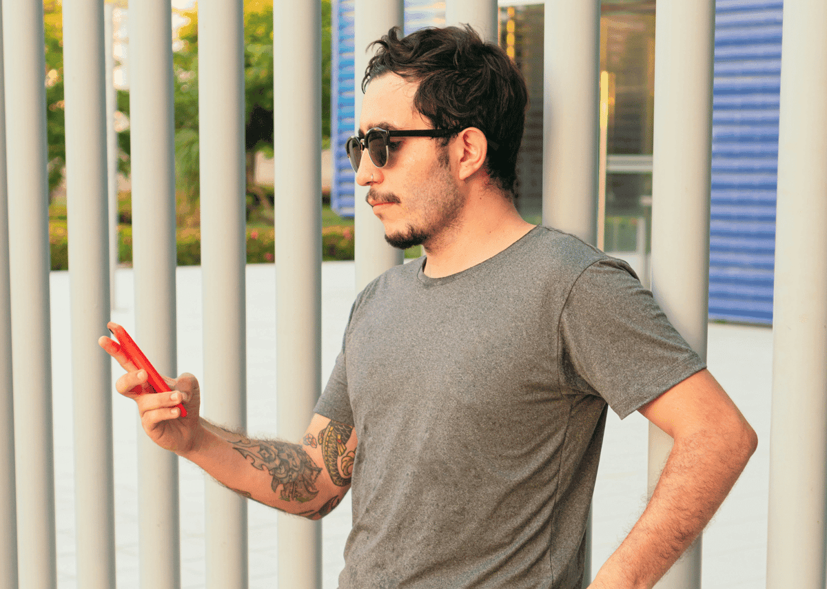 Person typing on smartphone, representing sending review request messages